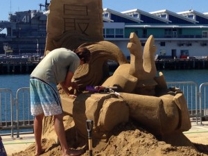 Sculptor crafting his entry (USS Midway CV-41 museum in background)